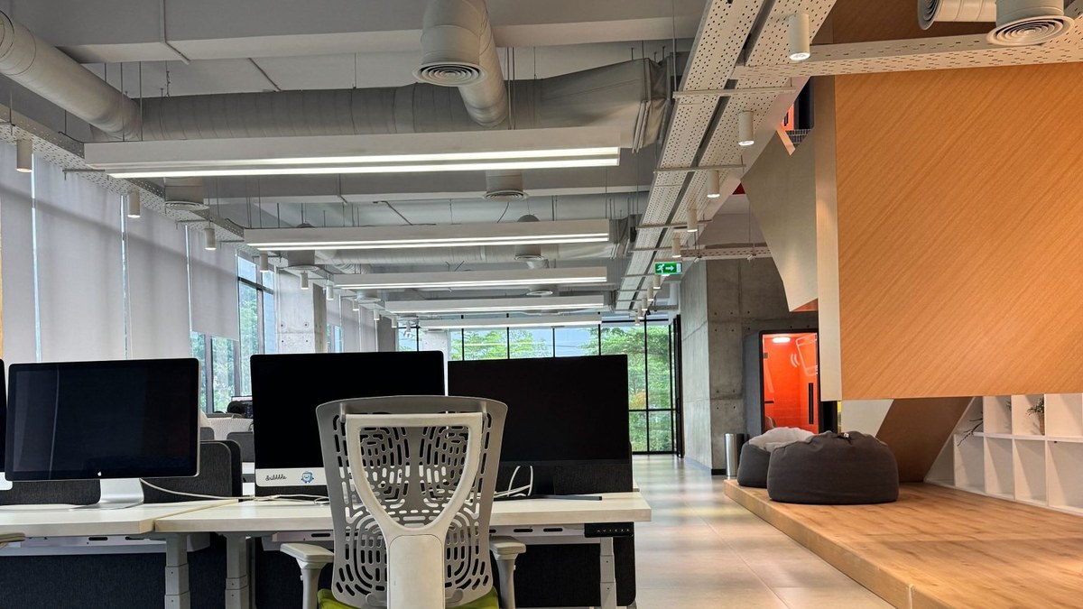 Modern open-plan office with rows of empty desks
