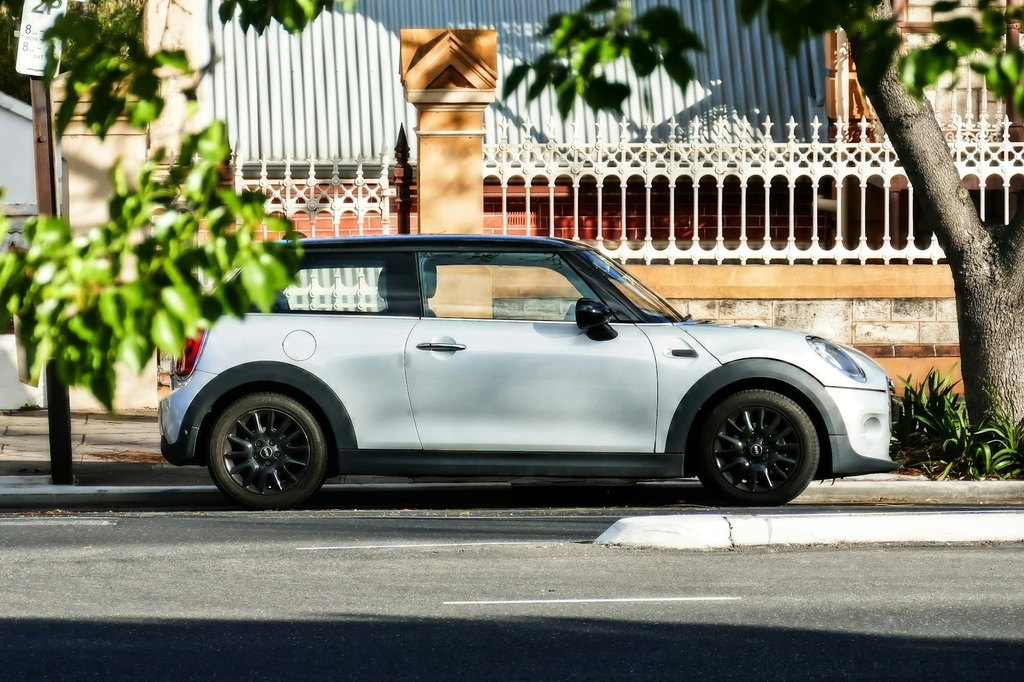 Small car parked on a tree-lined street